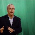 Michigan State University Professor David Closs speaking in front of a green screen about the importance of the value chain.
