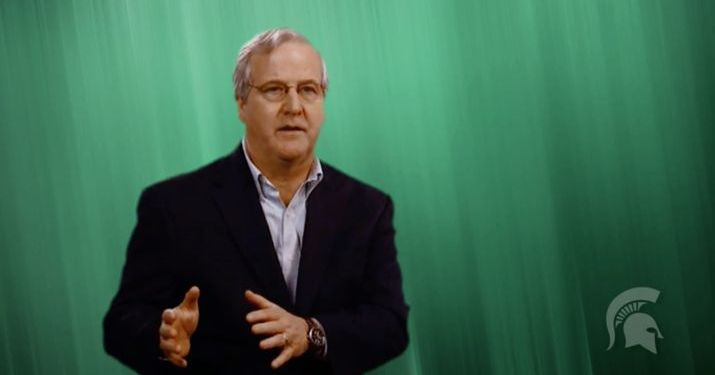 Michigan State University Professor David Closs speaking in front of a green screen about the importance of the value chain.
