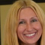 Pamela Tassinari, Business Leadership and Management grad, smiling at the camera.