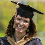 Ellen Lux, Management, Strategy and Leadership grad, smiling in her MSU graduate cap and gown.