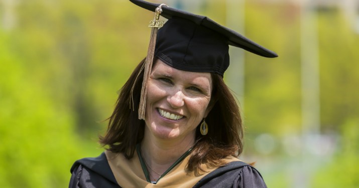 Ellen Lux, Management, Strategy and Leadership grad, smiling in her MSU graduate cap and gown.