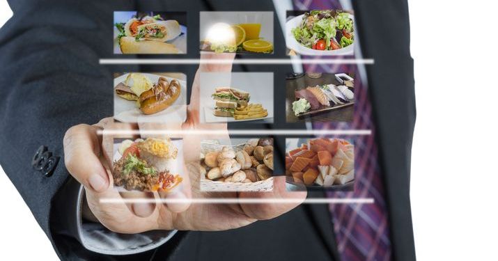 Man in a business suit ordering food off of a holographic menu.