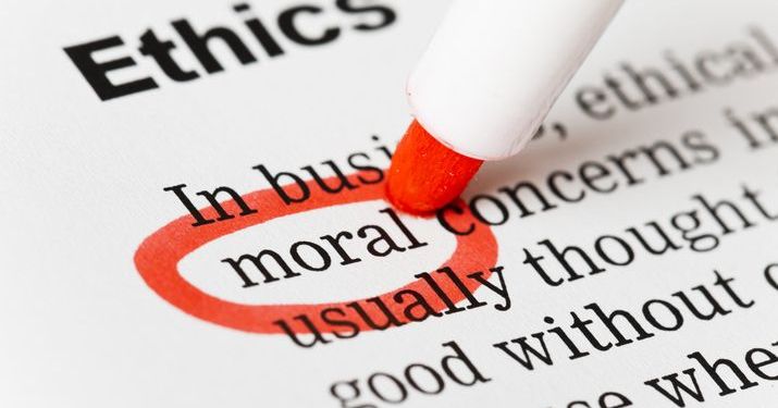 A sheet of paper that says "Ethics" at the top with some text underneath and a red circle being drawn with a marker around the word"moral".