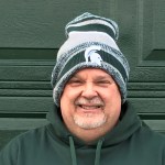 Charlie Grimm, who completed MSU's Master Certificate in Supply Chain Management and Logistics, wearing an MSU Spartans beanie.