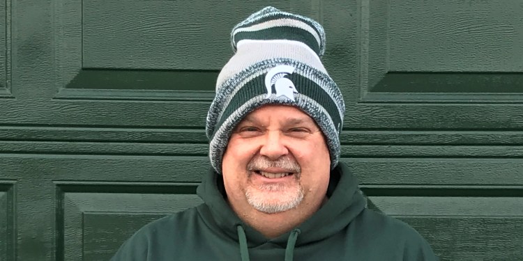 Charlie Grimm, who completed MSU's Master Certificate in Supply Chain Management and Logistics, wearing an MSU Spartans beanie.