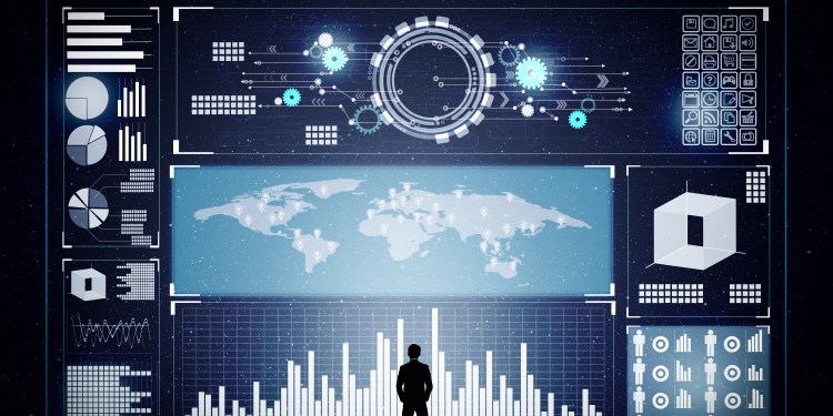 Businessman Standing In Front Of Wall-Sized Data Analytics Dashboard.