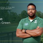 MS in Supply Chain Management student Malcolm Green standing on a balcony, arms crossed and looking straight ahead.