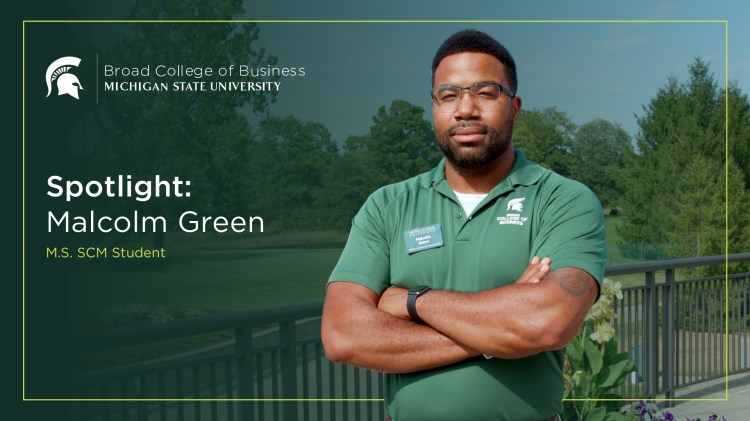 MS in Supply Chain Management student Malcolm Green standing on a balcony, arms crossed and looking straight ahead.