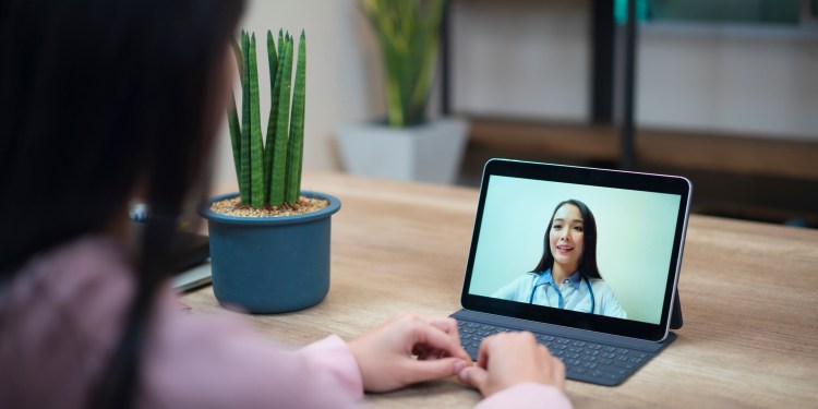 Doctor consults patient through tablet — telehealth in action