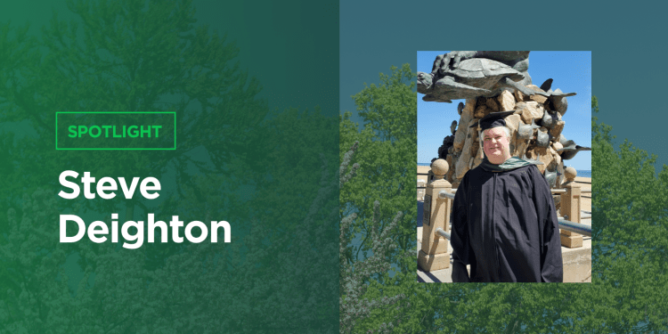 Cap and gown photo of Steve Deighton at the Virginia Beach waterfront.